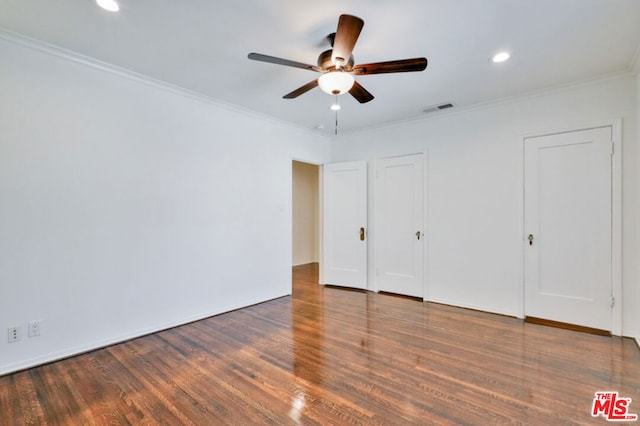 unfurnished bedroom with ceiling fan, dark hardwood / wood-style floors, and ornamental molding