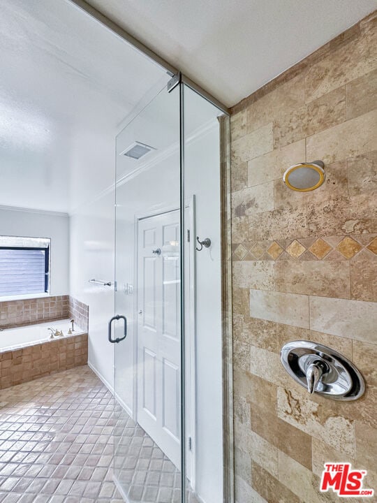 bathroom with shower with separate bathtub