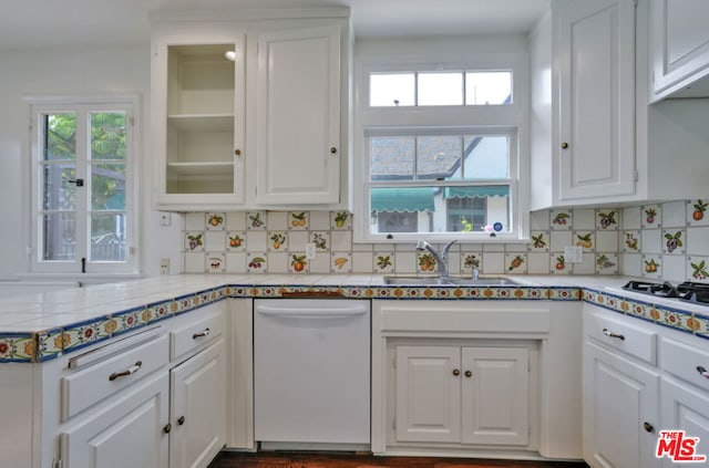 kitchen featuring decorative backsplash, white appliances, white cabinetry, and sink