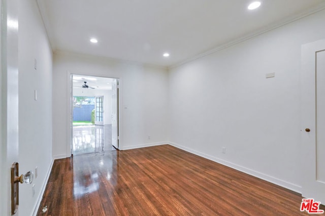 unfurnished room featuring crown molding, ceiling fan, and dark hardwood / wood-style floors