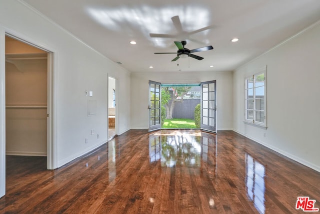 spare room with crown molding, ceiling fan, and dark hardwood / wood-style floors