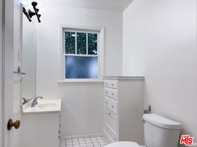 bathroom with tile patterned flooring, vanity, and toilet