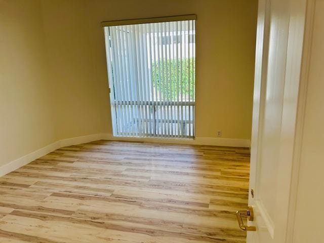 spare room featuring light hardwood / wood-style floors