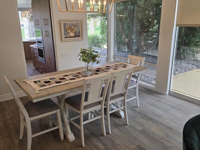 dining room featuring dark hardwood / wood-style flooring and a chandelier