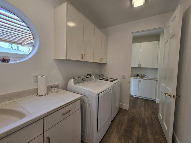 washroom with cabinets, dark hardwood / wood-style flooring, separate washer and dryer, and sink