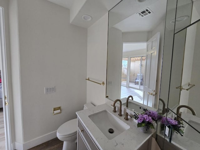 bathroom with vanity, wood-type flooring, and toilet