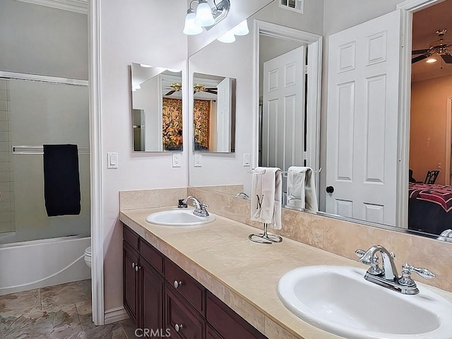 full bathroom featuring vanity, toilet, ceiling fan, and bath / shower combo with glass door