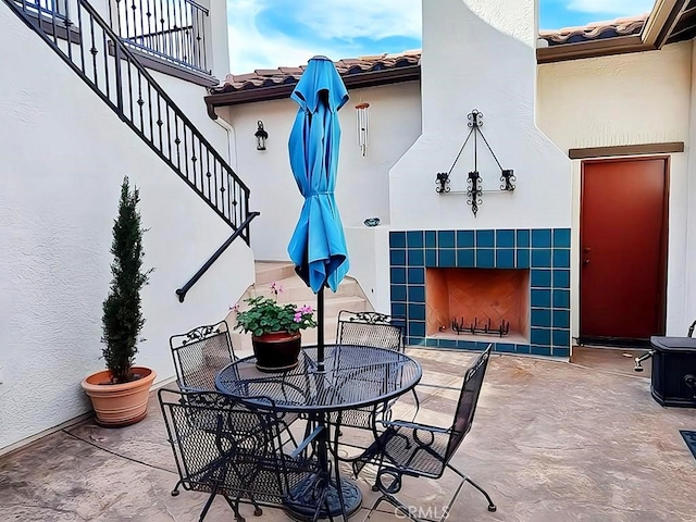 view of patio featuring a tiled fireplace