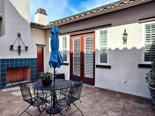 view of patio / terrace featuring a tiled fireplace