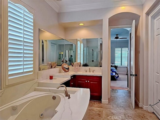 bathroom featuring ceiling fan, vanity, a healthy amount of sunlight, and ornamental molding