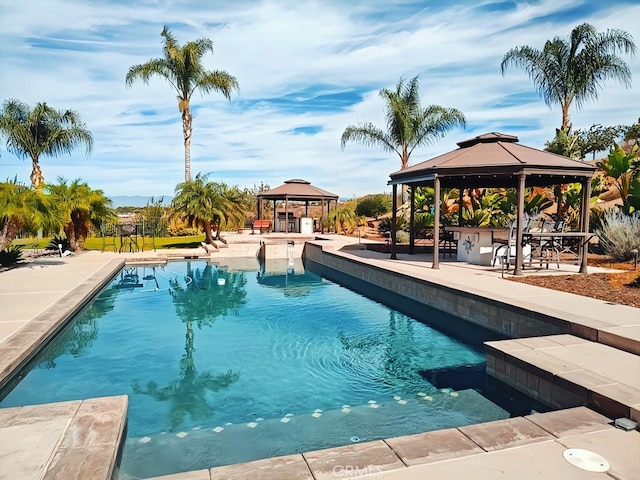 view of swimming pool featuring a gazebo, a patio, and a bar