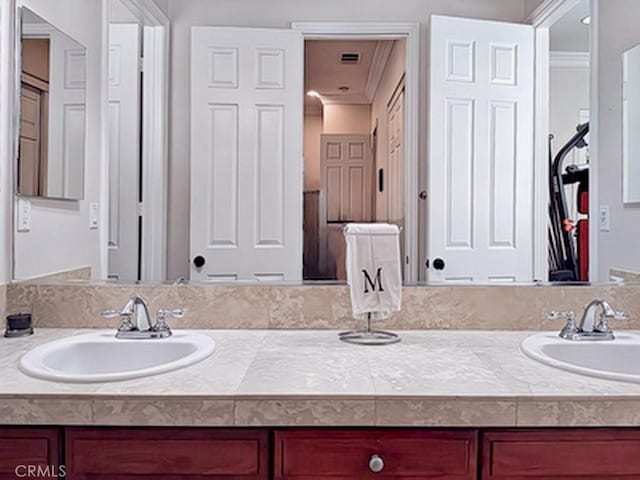 bathroom featuring vanity and crown molding