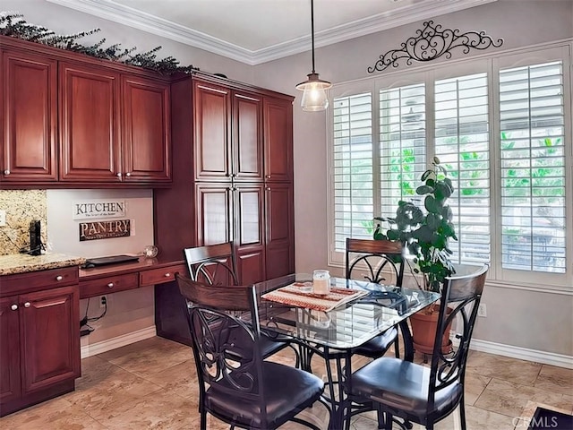 dining room with crown molding and built in desk