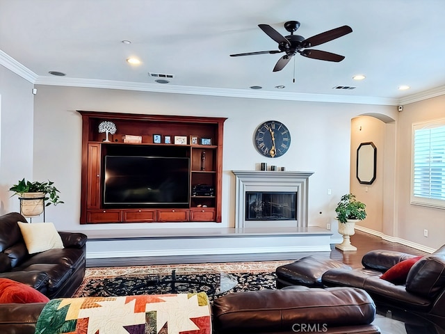 living room with ceiling fan and ornamental molding