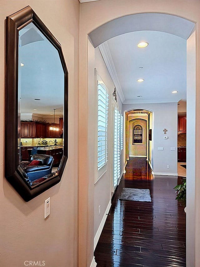 hall with crown molding and dark hardwood / wood-style floors