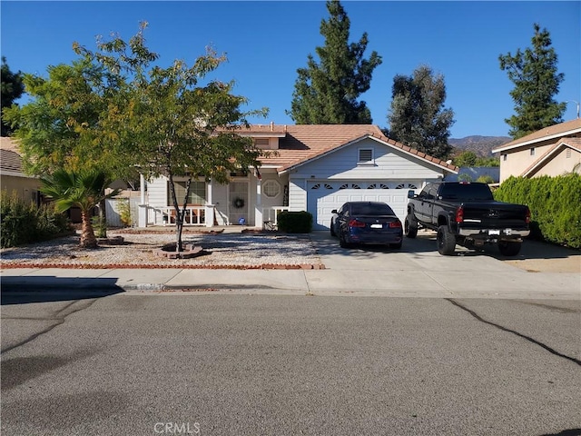 view of front facade featuring a mountain view and a garage