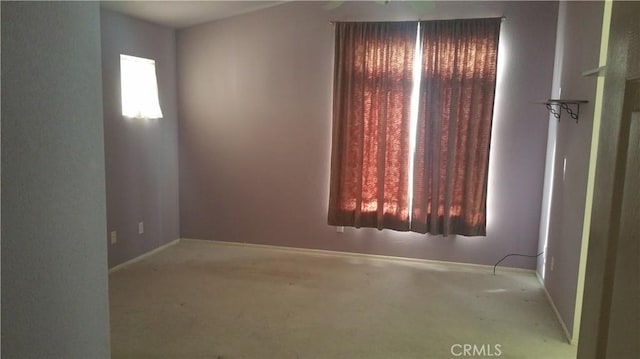 unfurnished room featuring light colored carpet