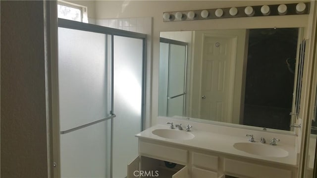 bathroom featuring vanity and an enclosed shower