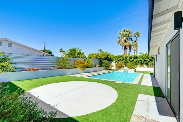 view of swimming pool featuring a patio area and a yard