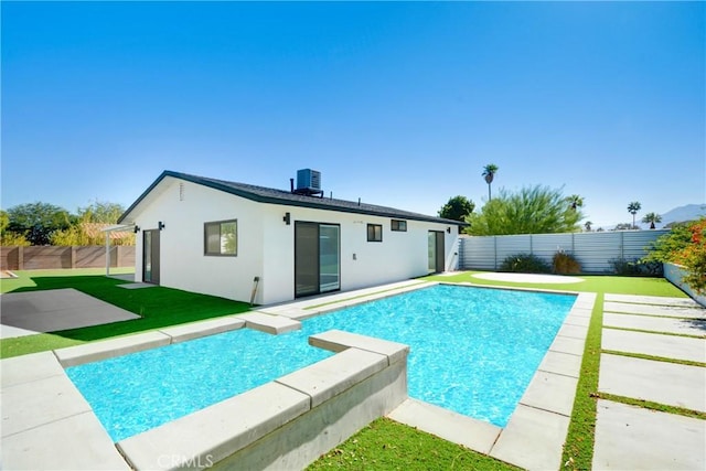 view of swimming pool featuring a yard, central AC unit, and a patio area