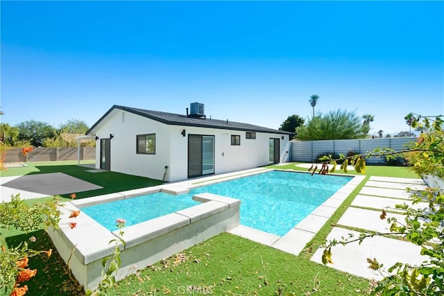 view of pool with a lawn and a patio