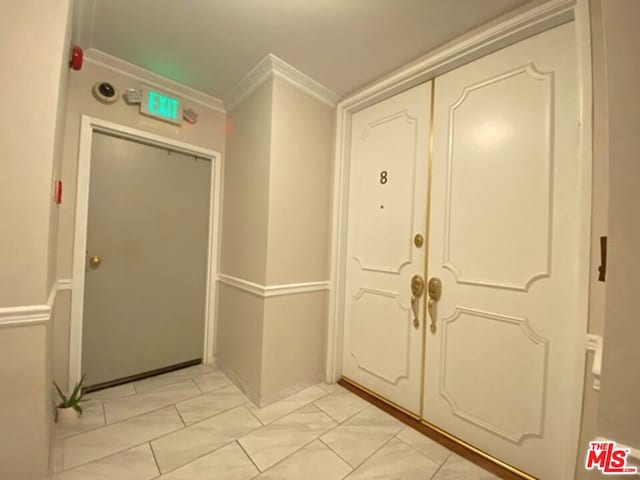 tiled entryway with crown molding