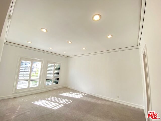 unfurnished room featuring carpet flooring and ornamental molding