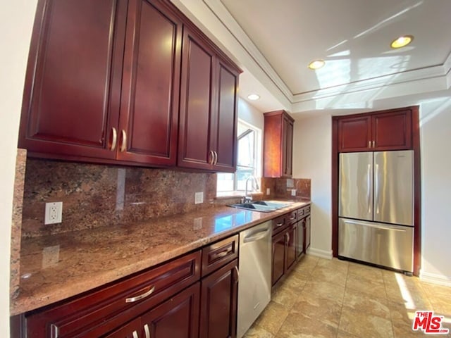 kitchen with decorative backsplash, sink, crown molding, light stone countertops, and appliances with stainless steel finishes