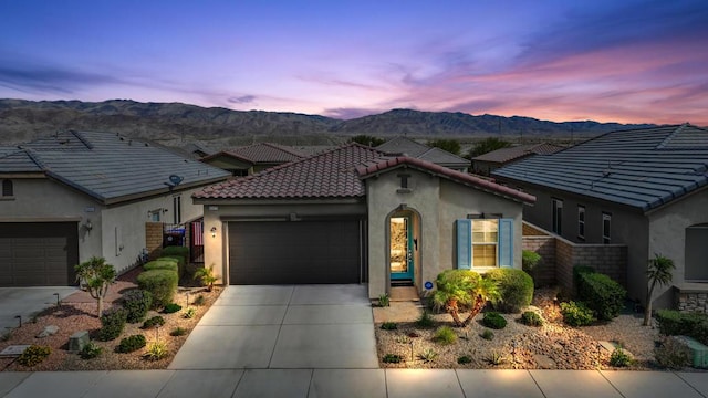 view of front facade with a mountain view and a garage