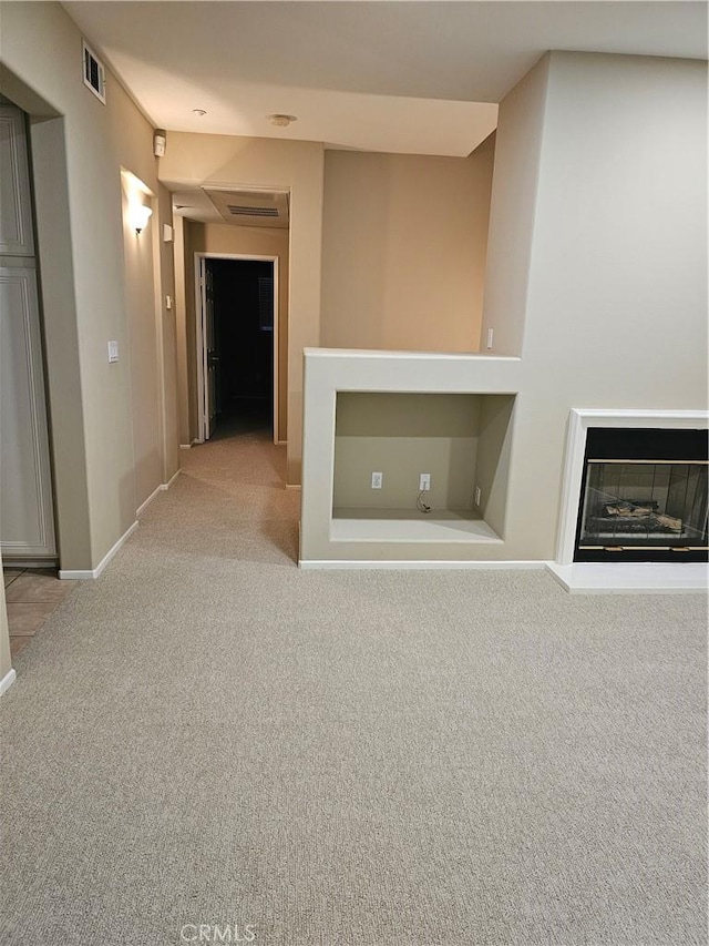 unfurnished living room featuring light carpet