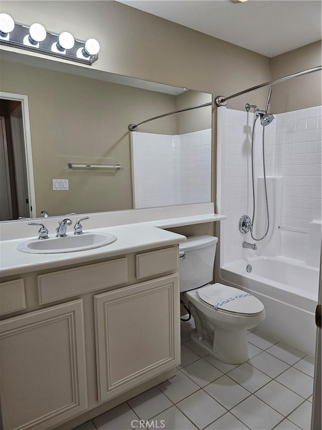 full bathroom with tile patterned floors, toilet, vanity, and washtub / shower combination