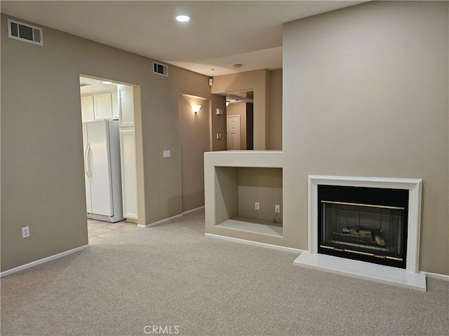 unfurnished living room with light carpet