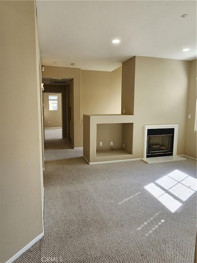 unfurnished living room featuring light colored carpet