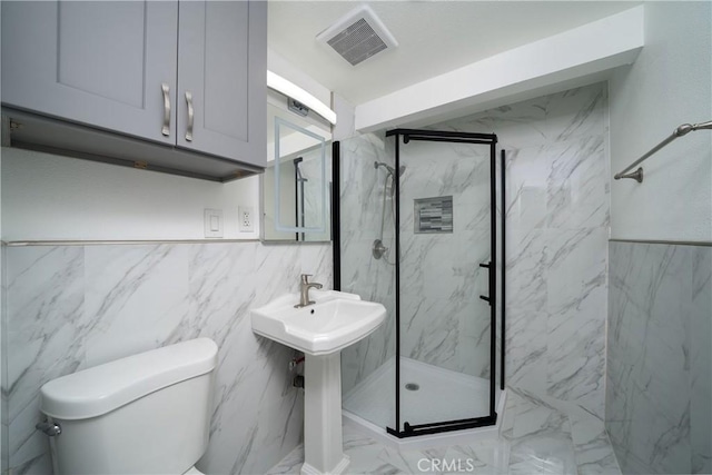 bathroom with an enclosed shower, tile walls, and toilet