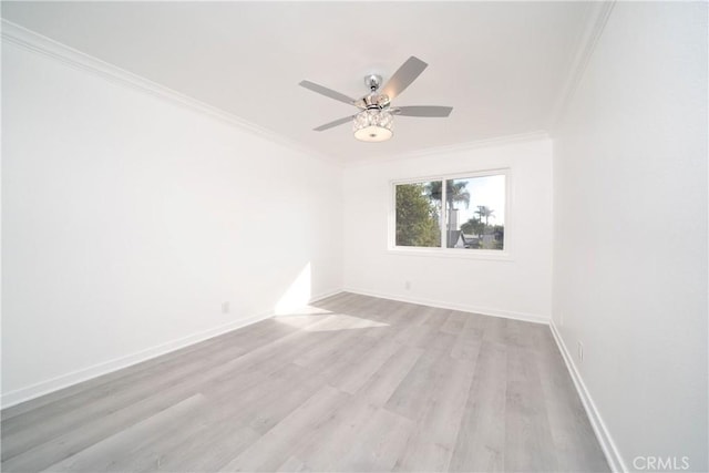 empty room with ceiling fan, light hardwood / wood-style floors, and crown molding