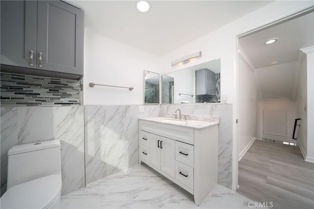 bathroom featuring hardwood / wood-style floors, vanity, and toilet