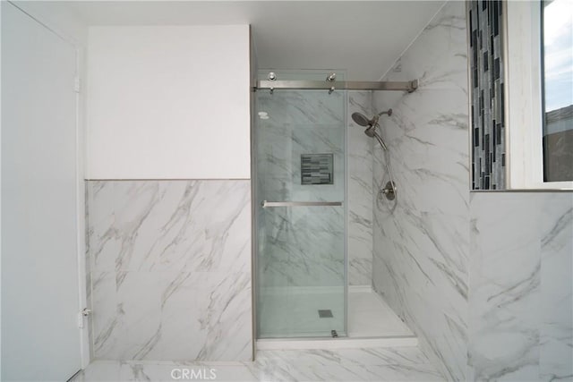 bathroom featuring a shower with door