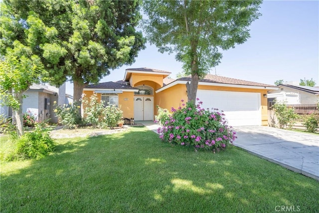 view of front of home with a front lawn and a garage