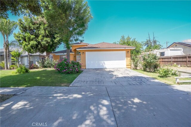 view of front of home with a front lawn and a garage