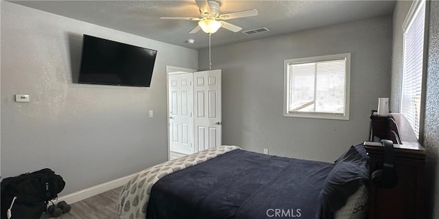 bedroom with hardwood / wood-style floors and ceiling fan