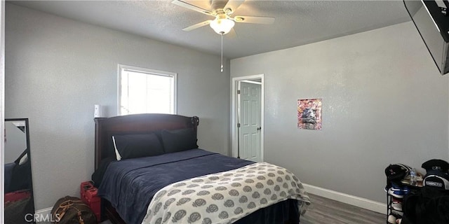 bedroom with hardwood / wood-style flooring and ceiling fan