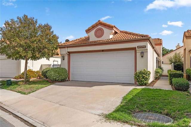 mediterranean / spanish house with a garage