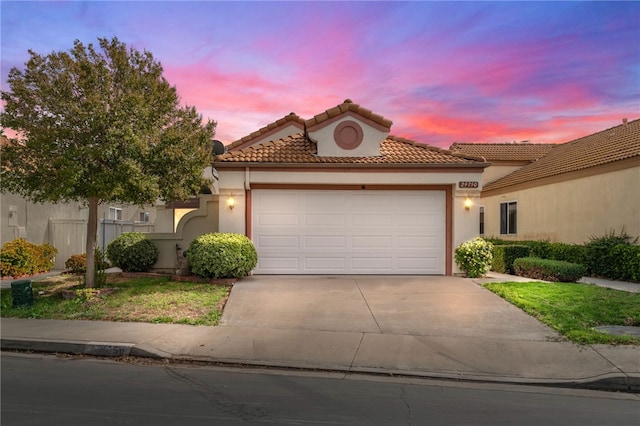 mediterranean / spanish-style home with a garage