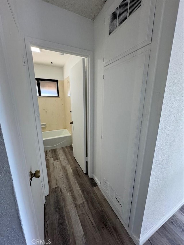 hallway with dark hardwood / wood-style floors