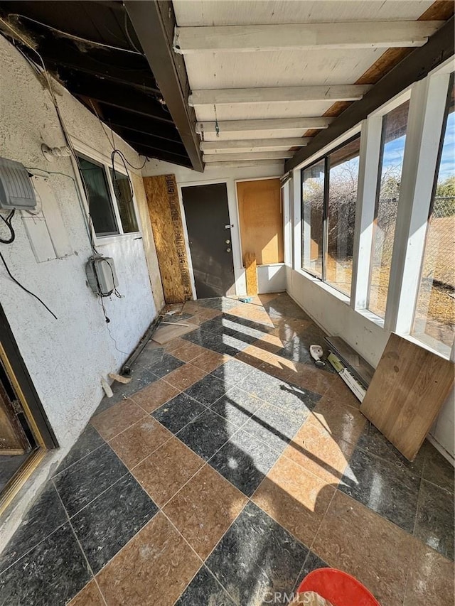 sunroom with beam ceiling