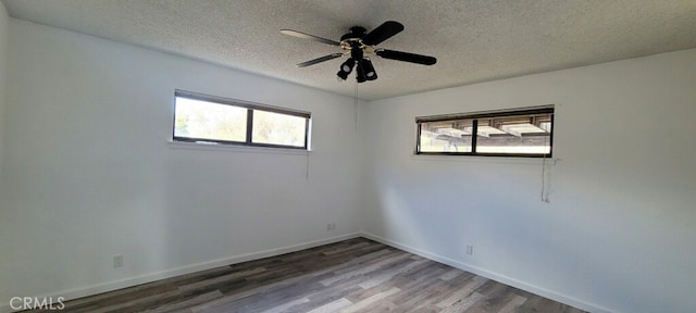 spare room with hardwood / wood-style flooring, ceiling fan, and a textured ceiling