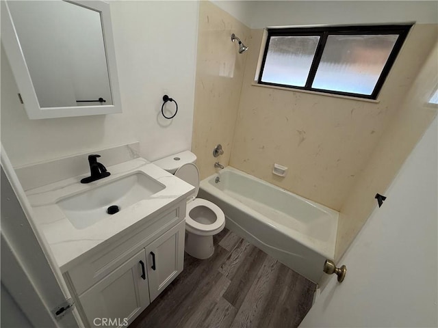 full bathroom featuring toilet, vanity, bathtub / shower combination, and wood finished floors