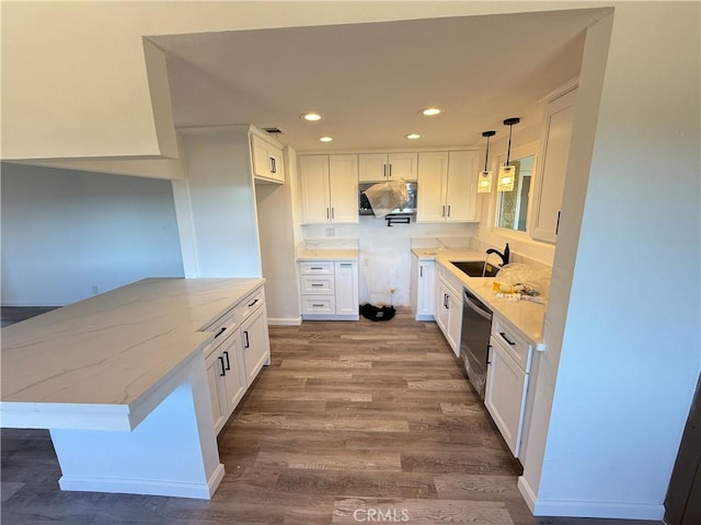 kitchen featuring dark wood finished floors, a sink, white cabinetry, and stainless steel dishwasher