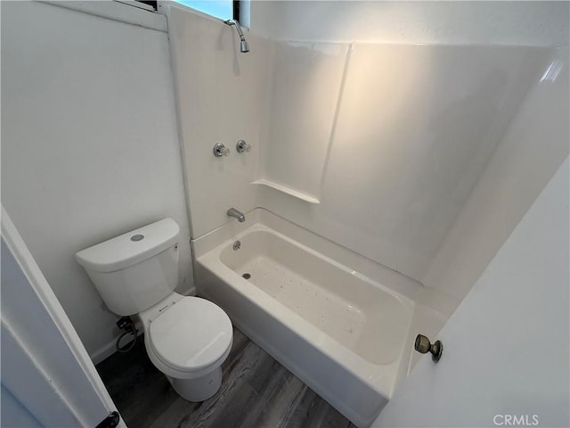 full bathroom featuring toilet, wood finished floors, and shower / bathtub combination