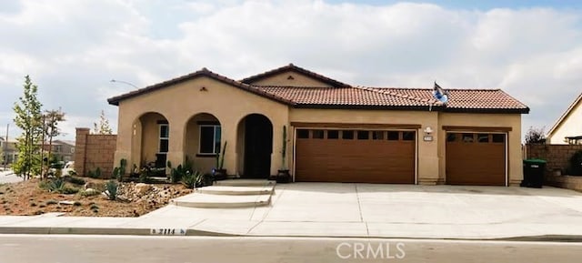 mediterranean / spanish home with a garage